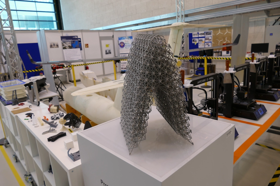 The image shows a model of the vertical tail plane to illustrate how airbus is using generative design, a use case of Manufacturing AI. 