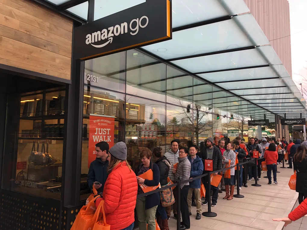 Image shows a long queue of people waiting to experience one of the first checkout free stores from Amazon GO.