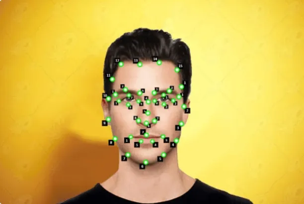This image shows how facial features and patterns are tagged and labelled with landmarking technique. This image is of a man's face with black and green tags on different places of the face.