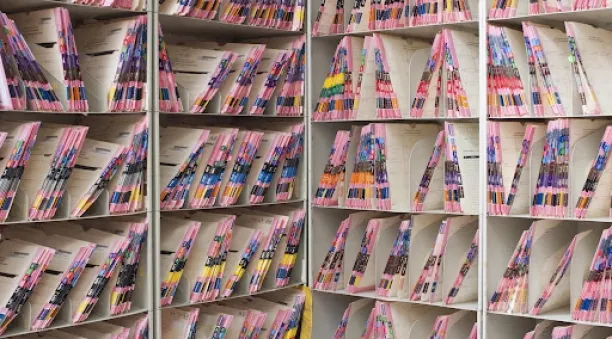 The picture shows a medical records shelves filled with documents.